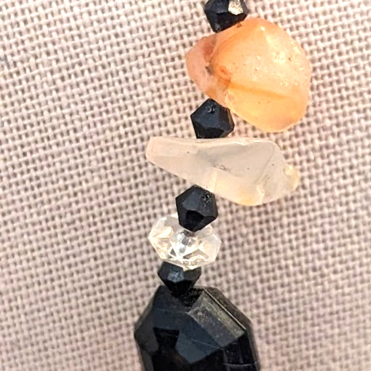 Black bead orange ball tassel necklace