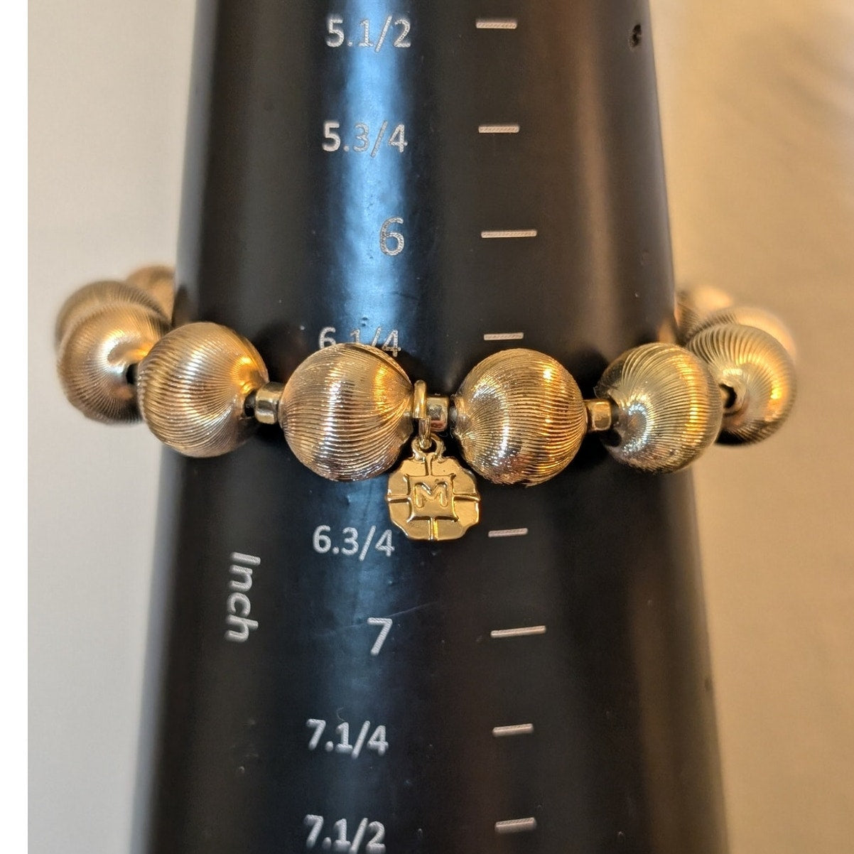 Lot of Two Gold Tone Bracelets Monet Textured Bead Stretch & 'M' Charm Bangle