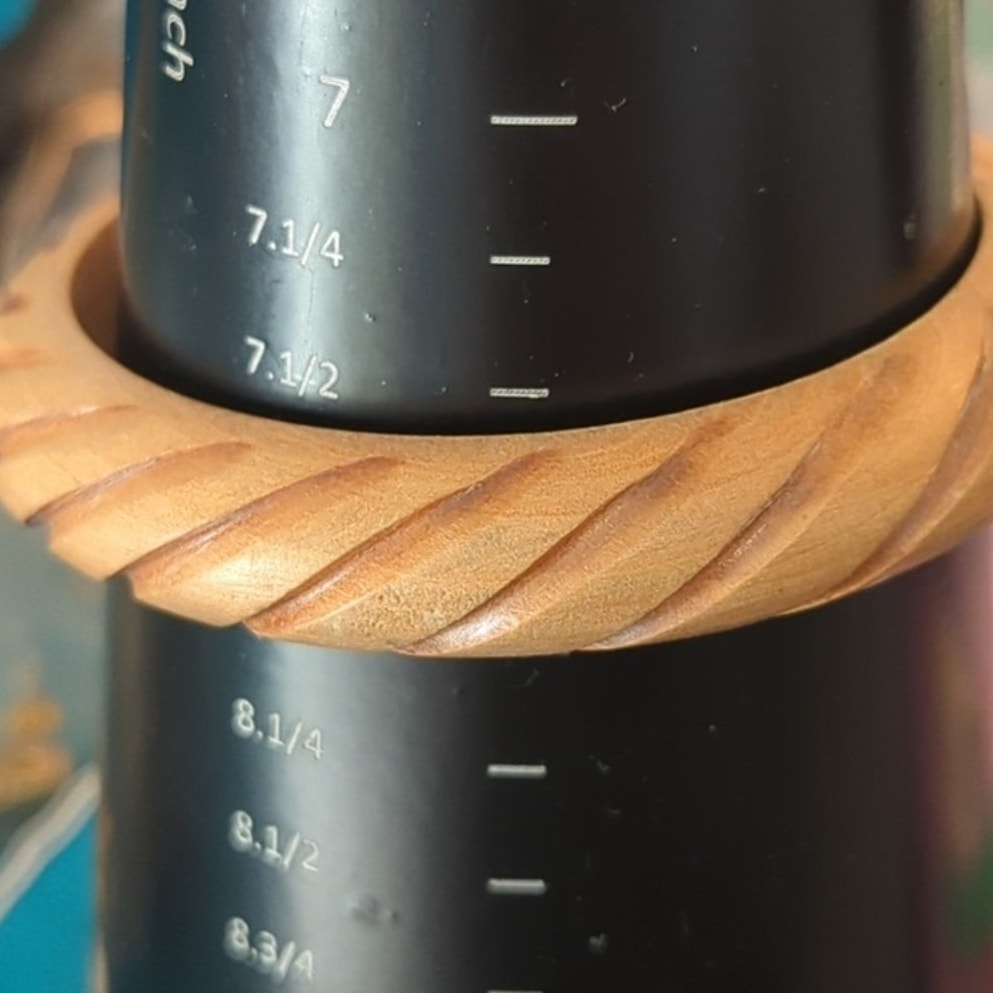 Two Wooden Bangle Bracelets One Carved with Swirl Pattern and One Inlay