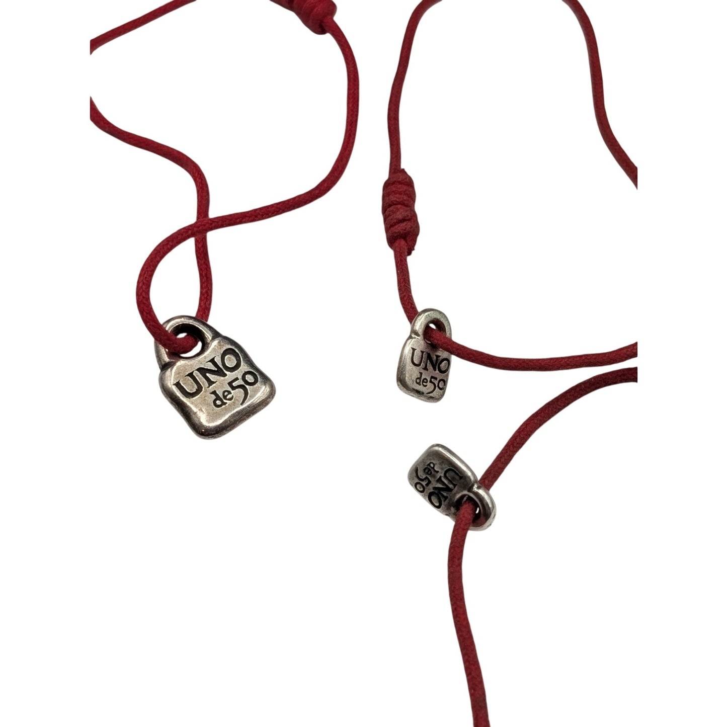 One Large & Two Smaller Uno de 50 Lock Charms on Red Corded Bracelets