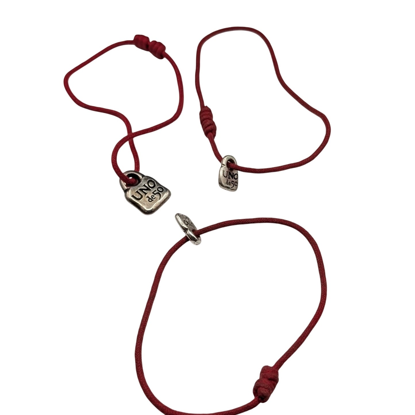 One Large & Two Smaller Uno de 50 Lock Charms on Red Corded Bracelets