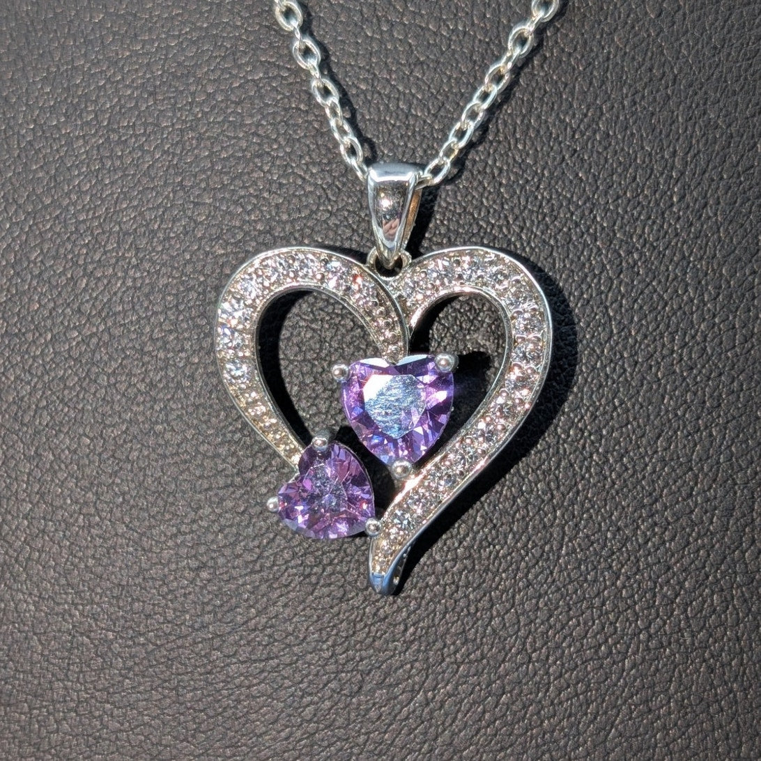 Two Purple Crystal Hearts Within A CZ Studded Heart Silver Tone Pendant Necklace