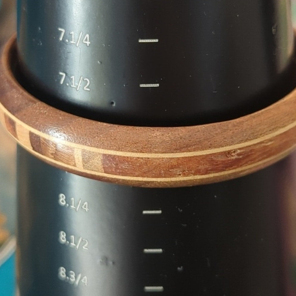 Two Wooden Bangle Bracelets One Carved with Swirl Pattern and One Inlay