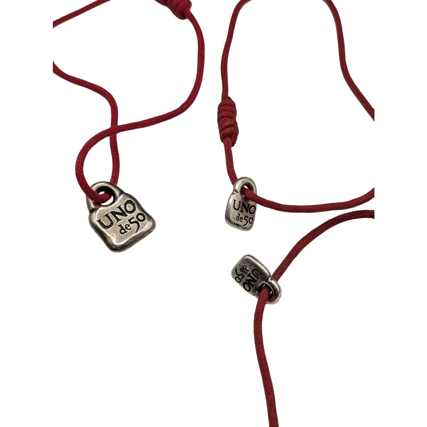 One Large & Two Smaller Uno de 50 Lock Charms on Red Corded Bracelets