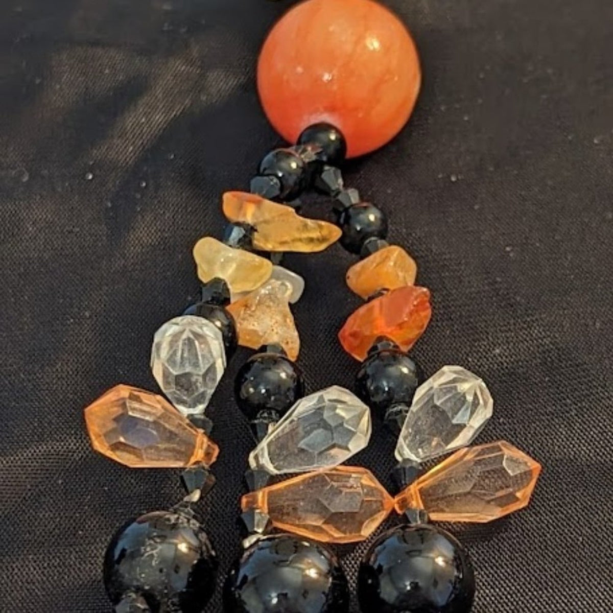 Black bead orange ball tassel necklace