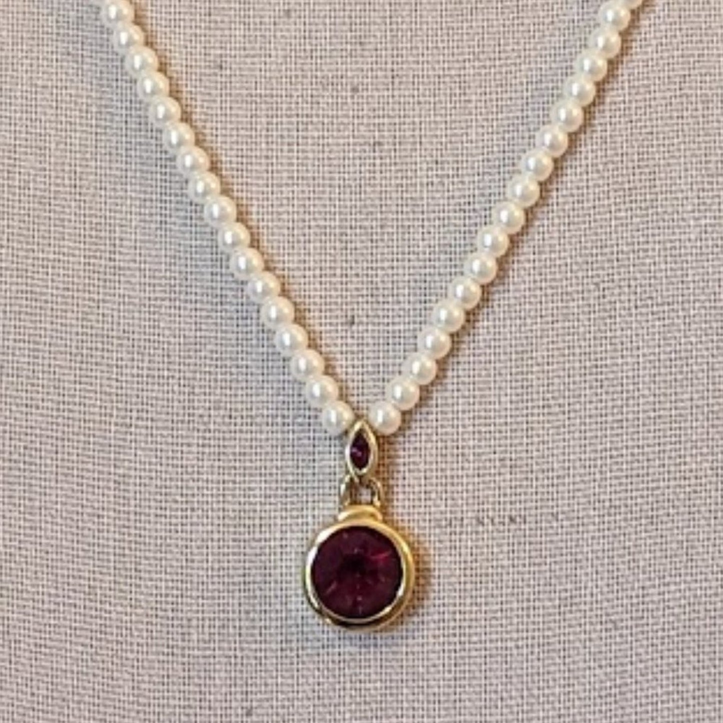 Faux Pearl Necklace with Bezel Set Red Crystal Pendant Set in Gold Tone Metal